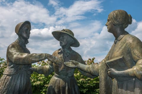 A statue showing Amelia Bloomer introducing Susan B. Anthony and Elizabeth Cady Stanton.