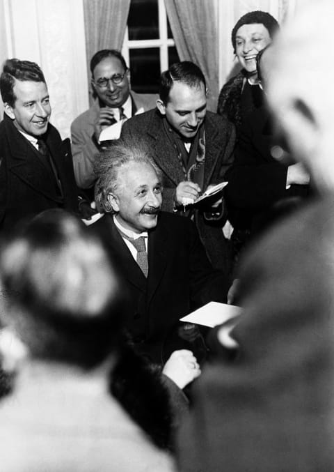 Albert Einstein answers reporters' questions.