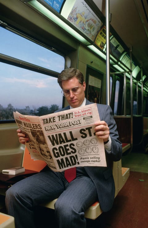 Reading about the Wall Street crash on the New York City subway.