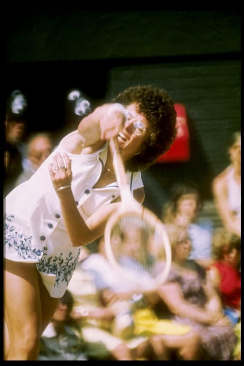 Billie Jean King serving the ball during a match at Wimbeldon, 1970.