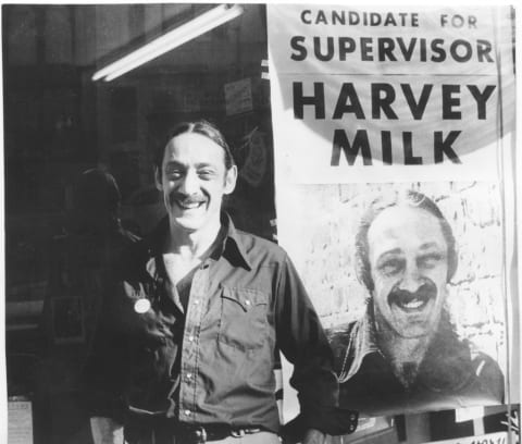 Harvey Milk with a campaign poster.