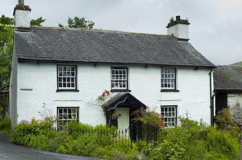 An English cottage featuring several sash windows.