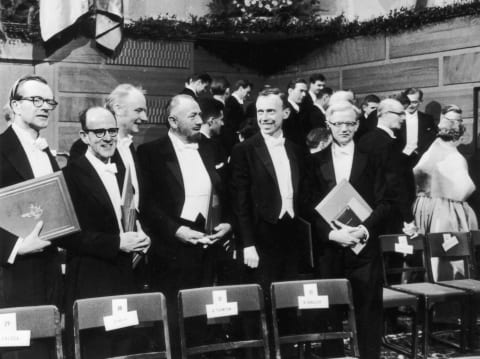 Professor Maurice Williams; Dr Max Perutz; Dr Francis Crick; John Steinbeck; Professor James Watson; Dr John C Kendrew at the Nobel Prize ceremony.