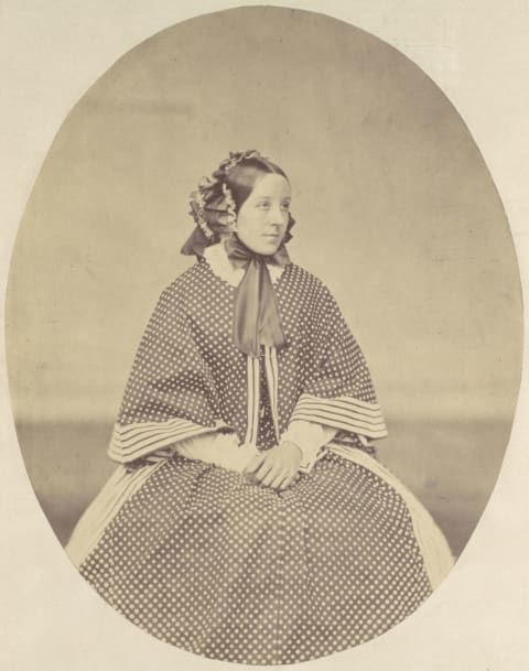 Portrait of Victorian-era woman in dotted dress.