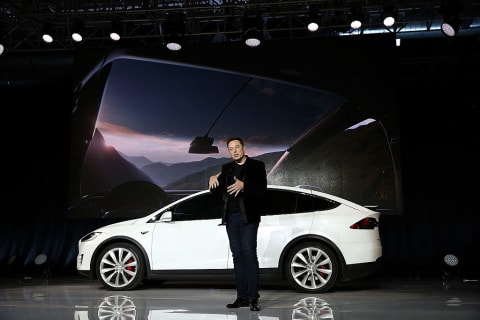 Elon Musk in front of a Tesla X.