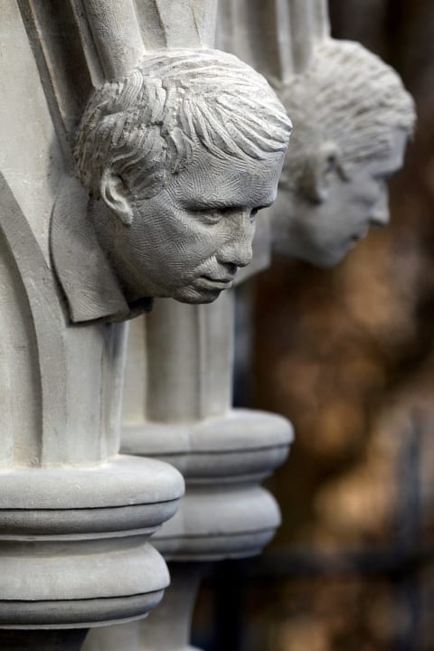 Human-like grotesques in Westminster Abbey's Chapter House.