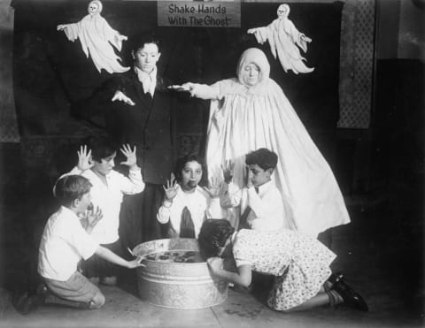 Children bobbing for apples, circa 1935