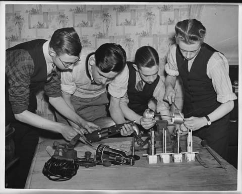 Young members of the British Interplanetary Society building a model rocket.