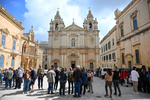 Tourists outside St. Paul's Cathedral in Mdina, Malta.