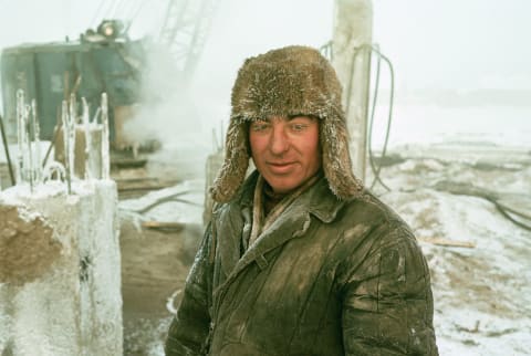 A construction worker placing piling into permafrost in Yakutsk.