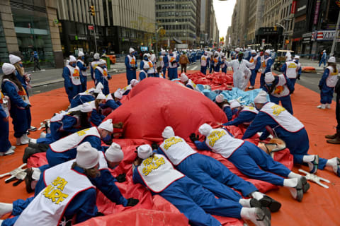 Volunteers deflate a balloon at the 95th Macy's Thanksgiving Day Parade.