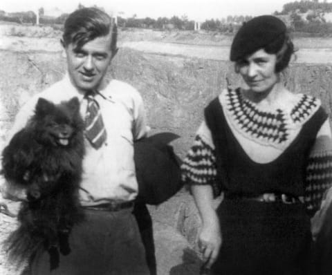 Rene Magritte (holding a schipperke) and his wife Georgette Berger.