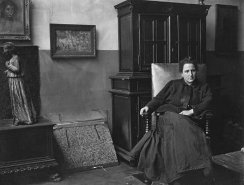 Gertrude Stein with some of the pieces in her art collection.