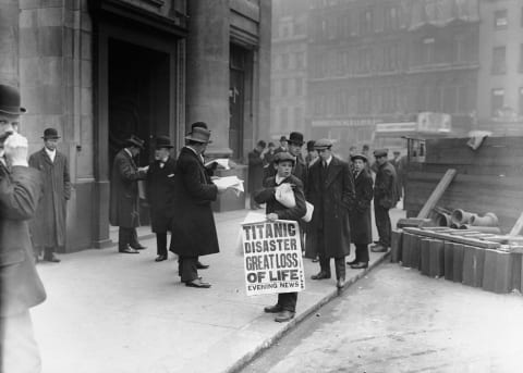 London newsboy holding a paper about the sinking of the ‘Titanic.’