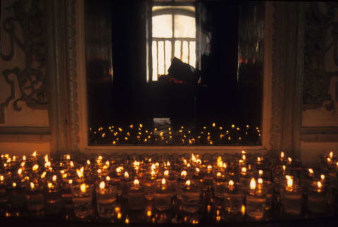 Candles in front of a mirror during a Nowruz ceremony at the Rostam Bagh Zoroastrian fire temple in Tehran, Iran.