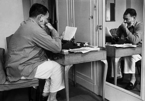 Hemingway at his typewriter.