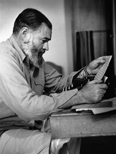 Ernest Hemingway reading a letter.