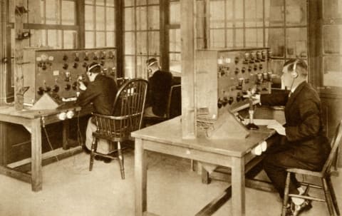 Operators communicating with pilots from the wireless transmission room at London's Croydon Aerodrome in 1928.