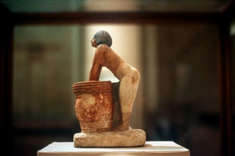 An Egyptian tomb model from Meketra (circa 2160 BCE) shows a figure brewing beer.