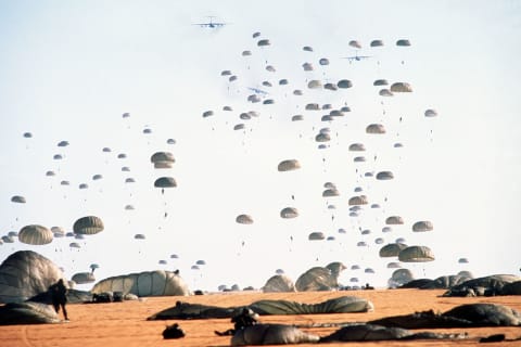 Members of the 82nd Airborne Division land via parachute.