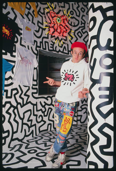 Keith Haring posing at Pop Shop opening.