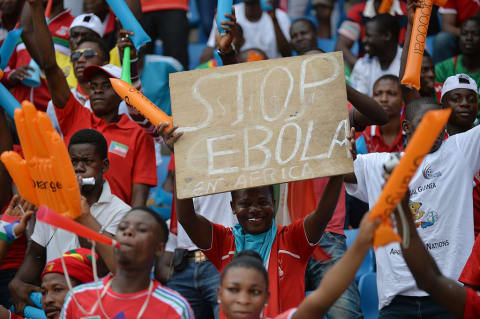 A soccer fan holds a “stop ebola” sign during a match between Equatorial Guinea and Congo in 2015.