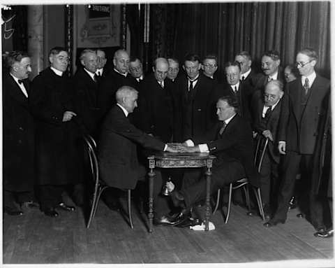 Houdini demonstrates a spiritualist trick.