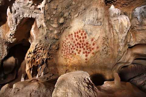 A replica of an abstract design using daubed red paint found in Chauvet Cave.