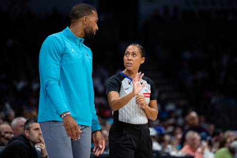 Head coach Charles Lee of the Charlotte Hornets talks with referee Sha’Rae Mitchell during the game against the Miami Heat on October 26, 2024.