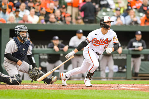 Apr 7, 2023; Baltimore, Maryland, USA; Baltimore Orioles second baseman Adam Frazier (12) hits a ball against the New York Yankees in April 2023