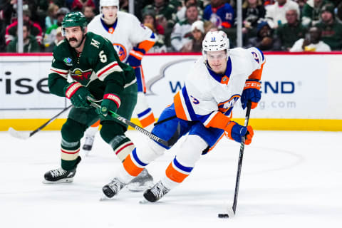 Jan 15, 2024; Saint Paul, Minnesota, USA; New York Islanders center Mathew Barzal (13) protects the