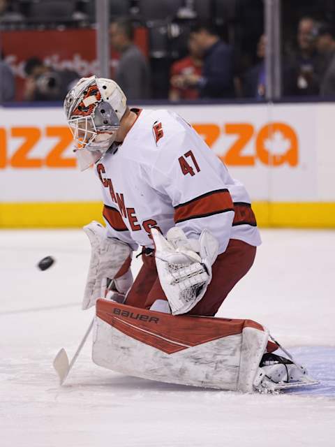 Feb 22, 2020; Toronto, Ontario, CAN; Carolina Hurricanes goaltender James Reimer (47) makes a save during warm up before a game against the Toronto Maple Leafs at Scotiabank Arena. Mandatory Credit: John E. Sokolowski-USA TODAY Sports