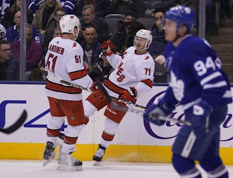 Feb 22, 2020; Toronto, Ontario, CAN; Carolina Hurricanes forward Lucas Wallmark (71) celebrates his goal against the Toronto Maple Leafs with Carolina Hurricanes defenseman Jake Gardiner (51) during the second period at Scotiabank Arena. Mandatory Credit: John E. Sokolowski-USA TODAY Sports