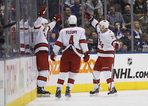 Feb 22, 2020; Toronto, Ontario, CAN; Carolina Hurricanes defenseman Haydn Fleury (4) and forward Nino Niederreiter (21) congratulate forward Martin Necas (88)  on his goal against the Toronto Maple Leafs at Scotiabank Arena. Carolina defeated Toronto. Mandatory Credit: John E. Sokolowski-USA TODAY Sports