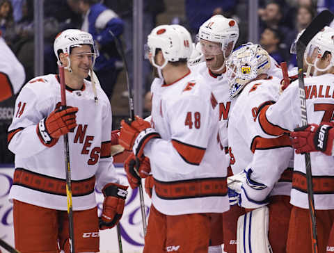 Feb 22, 2020; Toronto, Ontario, CAN; Carolina Hurricanes forward Justin Williams (14) and forward Jordan Martinook (48) and forward Jordan Staal (11) and emergency goaltender David Ayres (90) celebrate a win over the Toronto Maple Leafs at Scotiabank Arena. Mandatory Credit: John E. Sokolowski-USA TODAY Sports