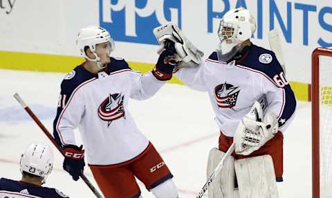 Sep 27, 2021; Pittsburgh, Pennsylvania, USA; Columbus Blue Jackets defenseman Stanislav Svozil (81) congratulates goalie Jet Greaves (60) after the Blue Jackets shutout the Pittsburgh Penguins 3-0 at PPG Paints Arena. Mandatory Credit: Charles LeClaire-USA TODAY Sports