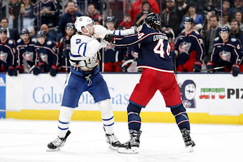 Dec 29, 2023; Columbus, Ohio, USA; Columbus Blue Jackets defenseman Erik Gudbranson (44) and Toronto Maple Leafs defenseman Simon Benoit (2) fight during the second period at Nationwide Arena. Mandatory Credit: Russell LaBounty-Imagn Images