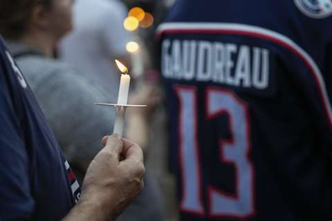 Sep 4, 2024; Columbus, OH, USA; Mourners gather for a candlelight vigil to remember Columbus Blue Jackets forward Johnny Gaudreau at Nationwide Arena. Gaudreau, along with his brother, Matthew, died in a bicycle crash last week. Mandatory Credit: Adam Cairns-Imagn Images via Columbus Dispatch/USA TODAY Network