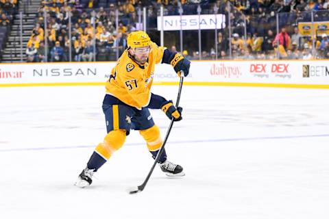 Oct 15, 2024; Nashville, Tennessee, USA;   Nashville Predators defenseman Dante Fabbro (57) takes a shot on goal against the Seattle Kraken during the first period at Bridgestone Arena. Mandatory Credit: Steve Roberts-Imagn Images