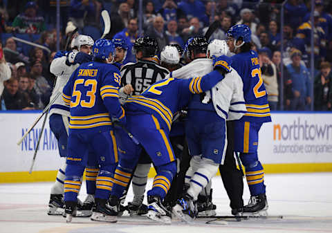 Dec 21, 2023; Buffalo, New York, USA;  Toronto Maple Leafs and Buffalo Sabres players in a scrum