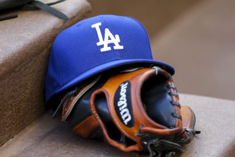 Los Angeles Dodgers hat and glove in the dugout