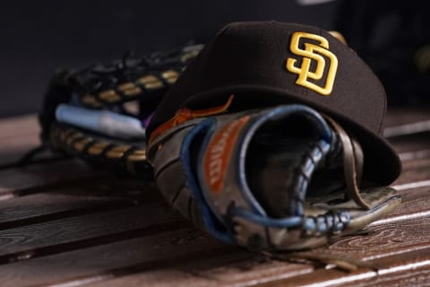 San Diego Padres hat and glove in the dugout