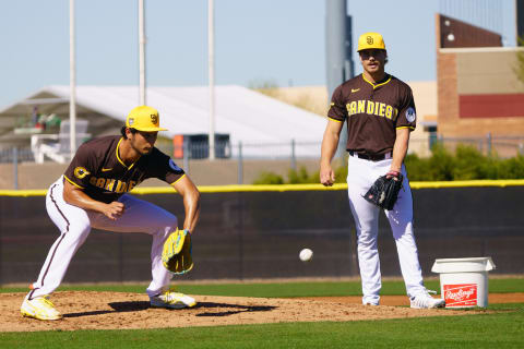 Feb 12, 2024; Peoria, AZ, USA;  San Diego Padres pitchers Yu Darvish (11) (left) and Drew Thorpe