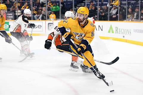 Jan 9, 2024; Nashville, Tennessee, USA; Nashville Predators center Tommy Novak (82) handles the puck