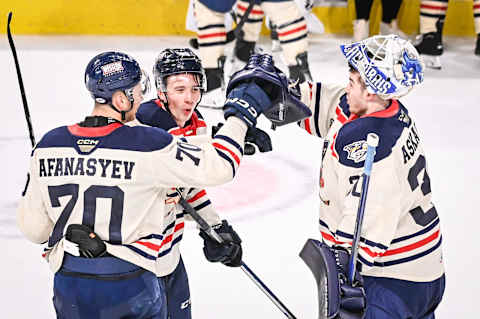 Milwaukee Admirals goaltender Yaroslav Askarov celebrates with left wing Egor Afanasyev and center