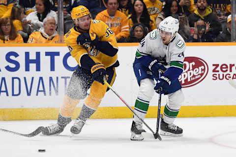 Dec 19, 2023; Nashville, Tennessee, USA; Vancouver Canucks center Pius Suter (24) passes the puck