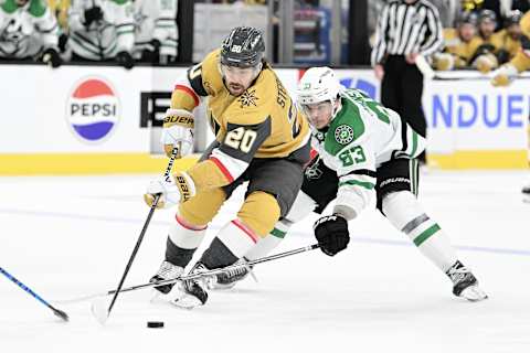 Apr 27, 2024; Las Vegas, Nevada, USA;Vegas Golden Knights center Chandler Stephenson (20) battles for the puck with Dallas Stars center Wyatt Johnston (53) in the third period in game three of the first round of the 2024 Stanley Cup Playoffs at T-Mobile Arena. Mandatory Credit: Candice Ward-USA TODAY Sports