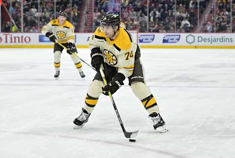 Mar 14, 2024; Montreal, Quebec, CAN; Boston Bruins forward Jake DeBrusk (74) plays the puck during the third period of the game against the Montreal Canadiens at the Bell Centre. Mandatory Credit: Eric Bolte-USA TODAY Sports