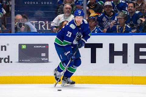 Apr 23, 2024; Vancouver, British Columbia, CAN; Vancouver Canucks forward Elias Lindholm (23) handles the puck against the Nashville Predators during the first period in game two of the first round of the 2024 Stanley Cup Playoffs at Rogers Arena. Mandatory Credit: Bob Frid-USA TODAY Sports