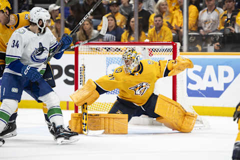 May 3, 2024; Nashville, Tennessee, USA; during the second period in game six of the first round of the 2024 Stanley Cup Playoffs at Bridgestone Arena. Mandatory Credit: Steve Roberts-USA TODAY SportsNashville Predators goaltender Juuse Saros (74) blocks the puck against the Vancouver Canucks 